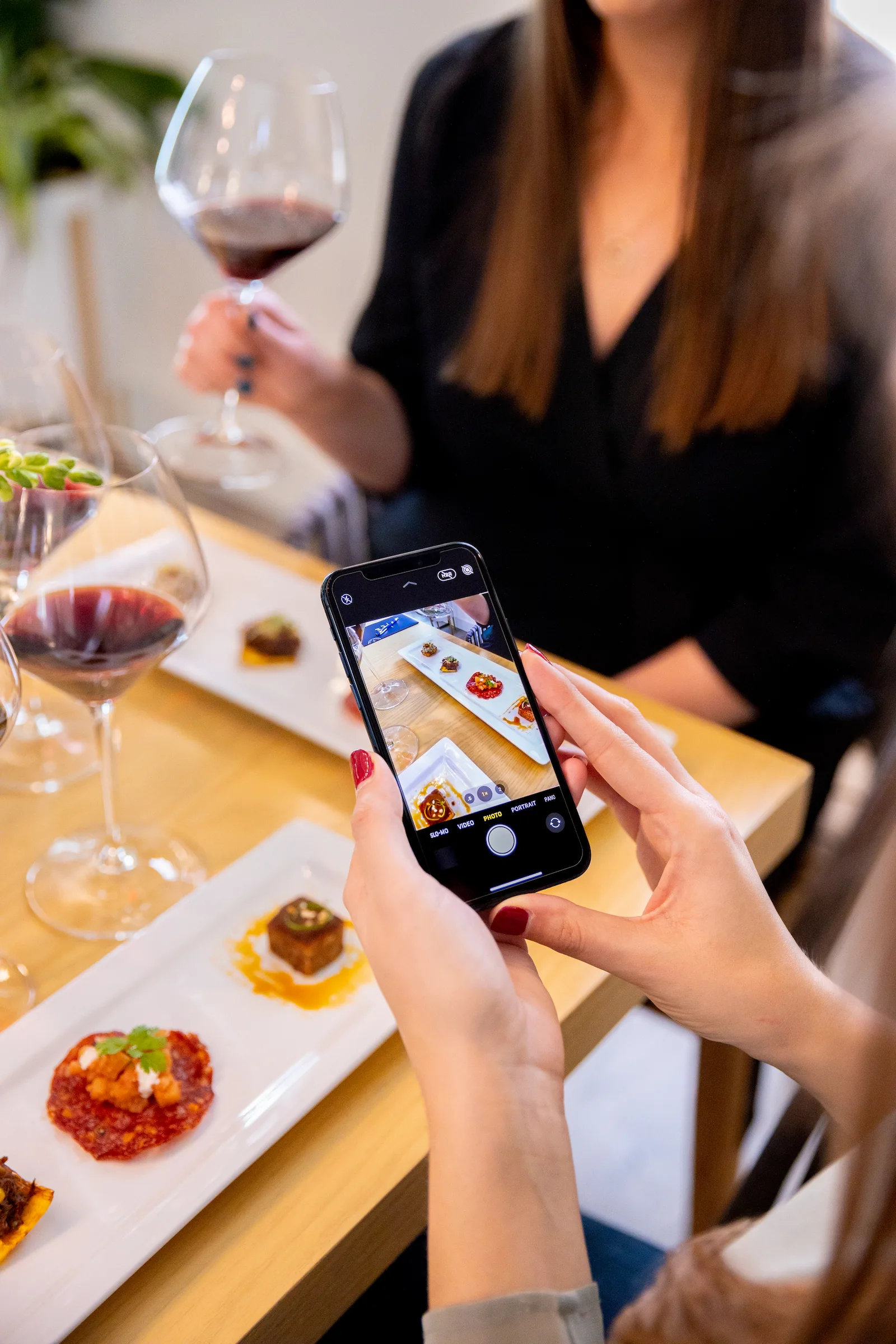 Woman photographs wine country tasting bites at Walt Wines.