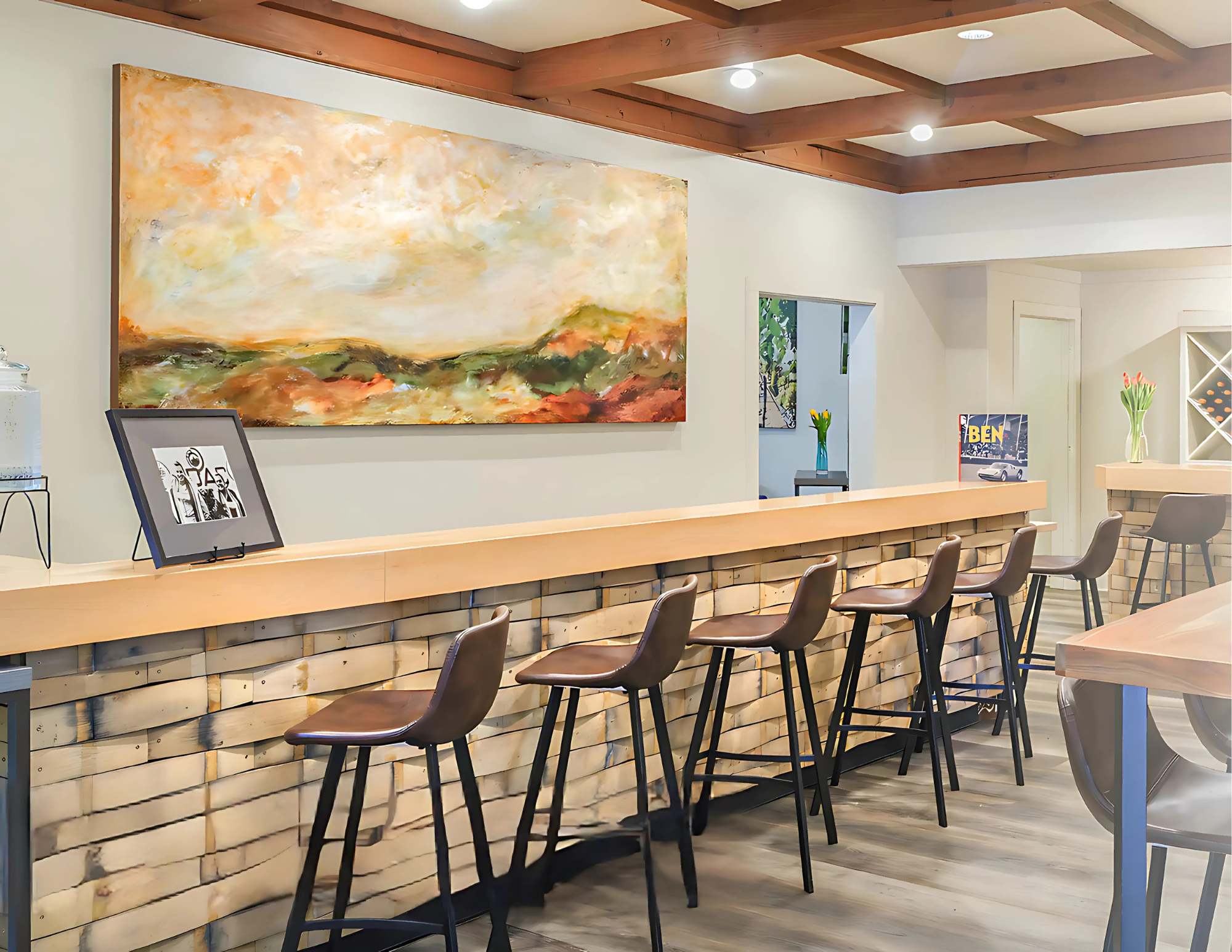 Bernardus tasting room bar with artwork and wine bottles.
