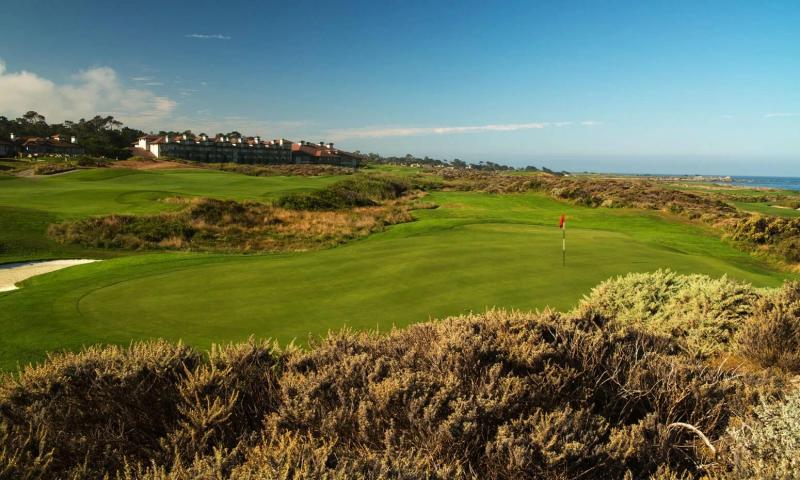 Golf course with ocean view and buildings at Pebble Beach, California.