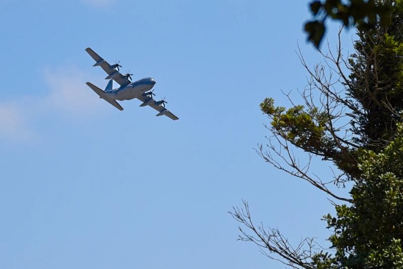 A C-130 aircraft flies over the Santa Lucia Highlands wine region.