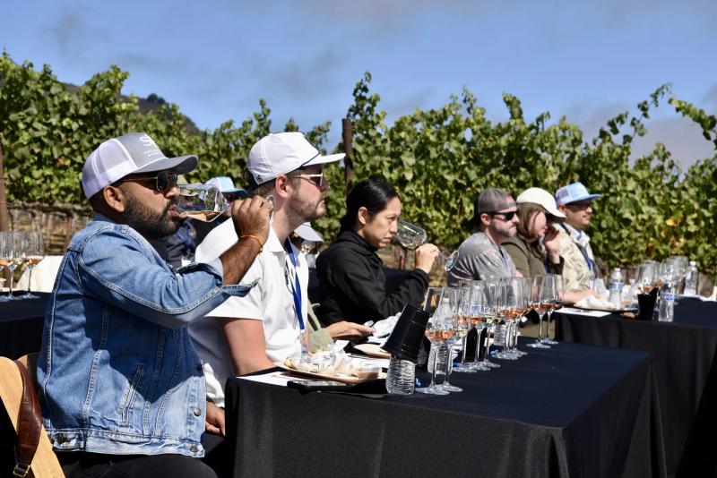 Sommeliers taste wine at Caraccioli-Escolle Vineyard during a Santa Lucia Highlands education event.