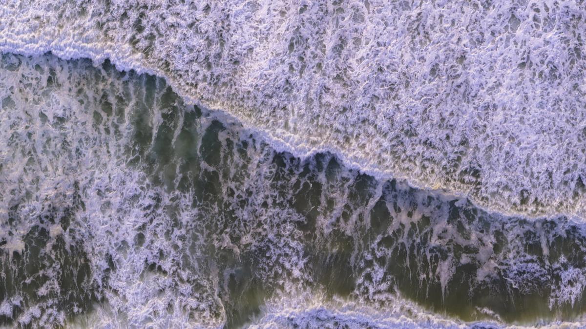 Aerial view of crashing waves near the Santa Lucia Highlands wine region in Monterey County, California.