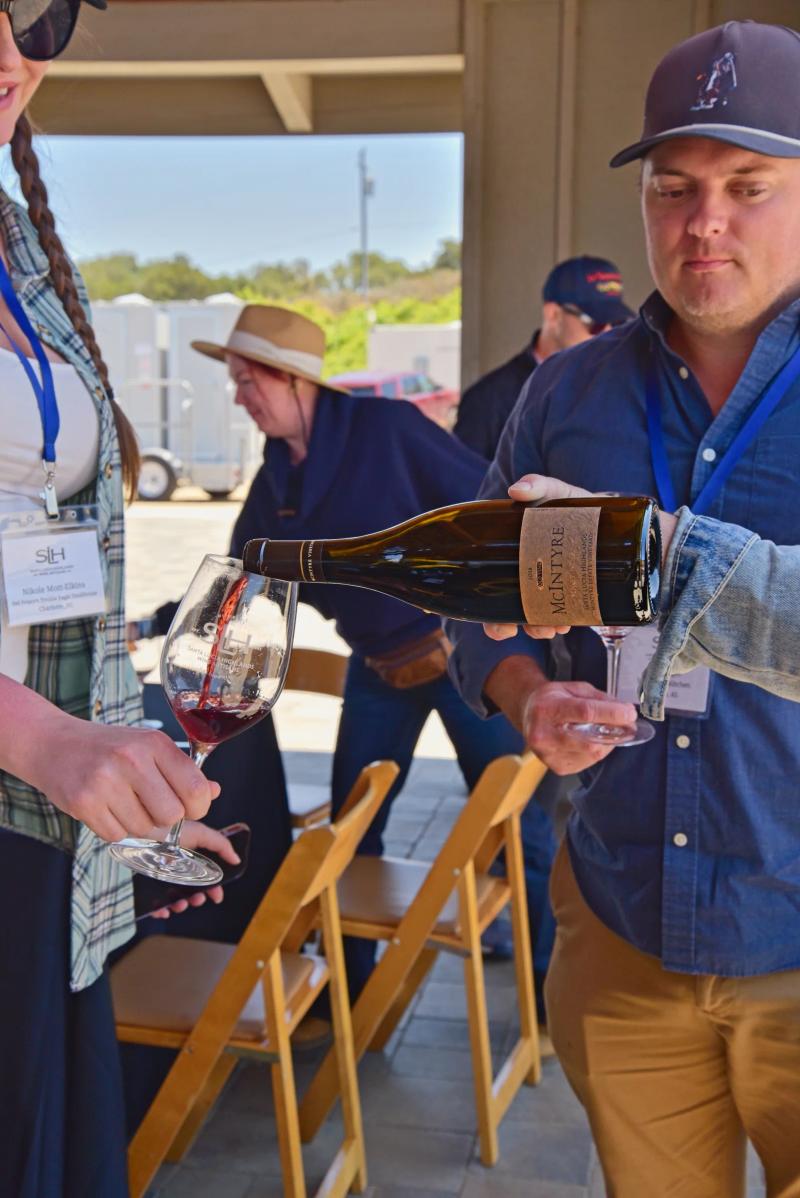 McIntyre Wines sommelier pours wine at SLH Monterey education event.