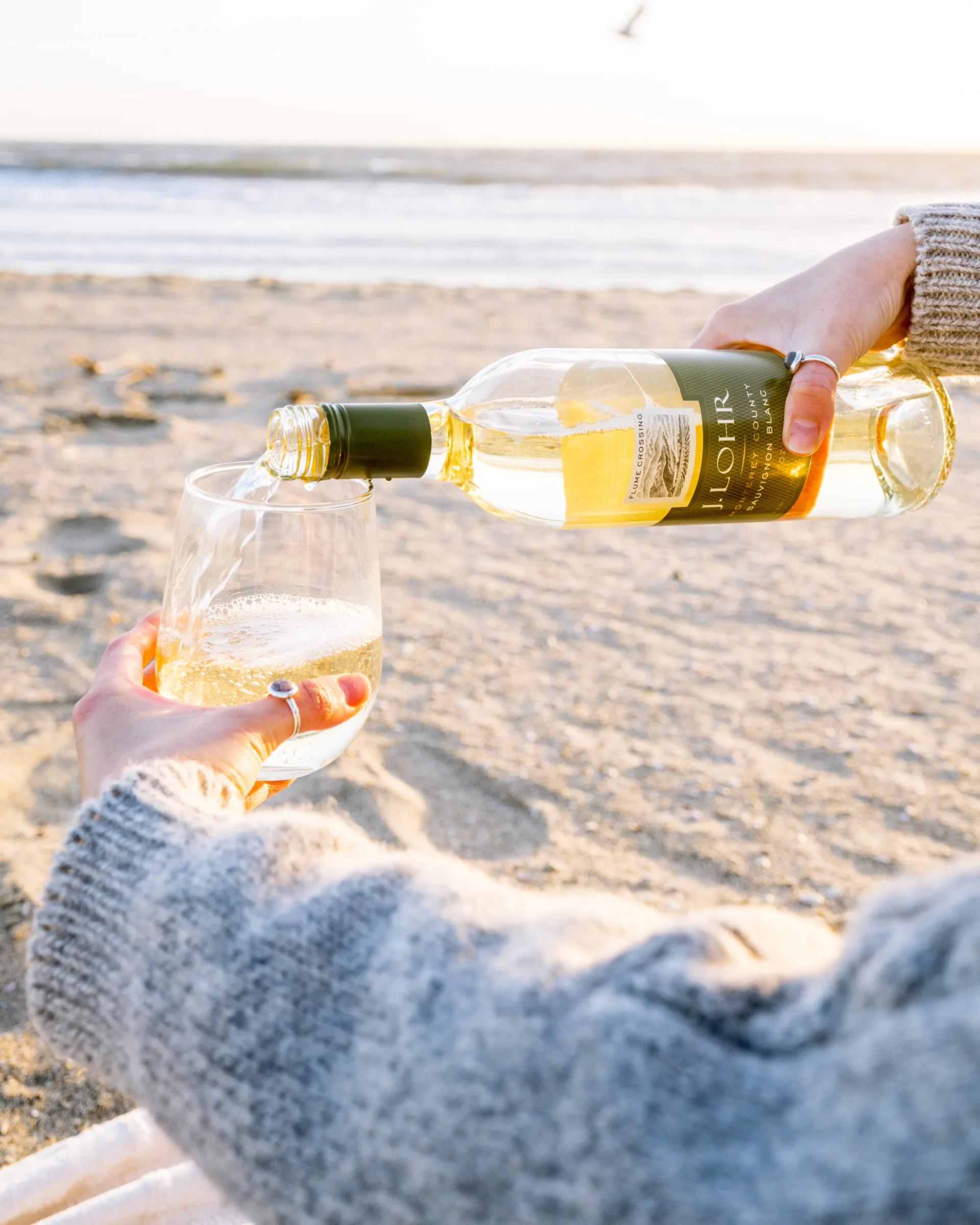 J. Lohr wine being poured on a beach in Santa Lucia Highlands, Monterey County, California.
