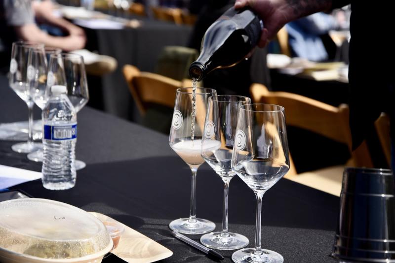 Sommelier education event at Caraccioli-Escolle Vineyard, Santa Lucia Highlands, pouring wine.