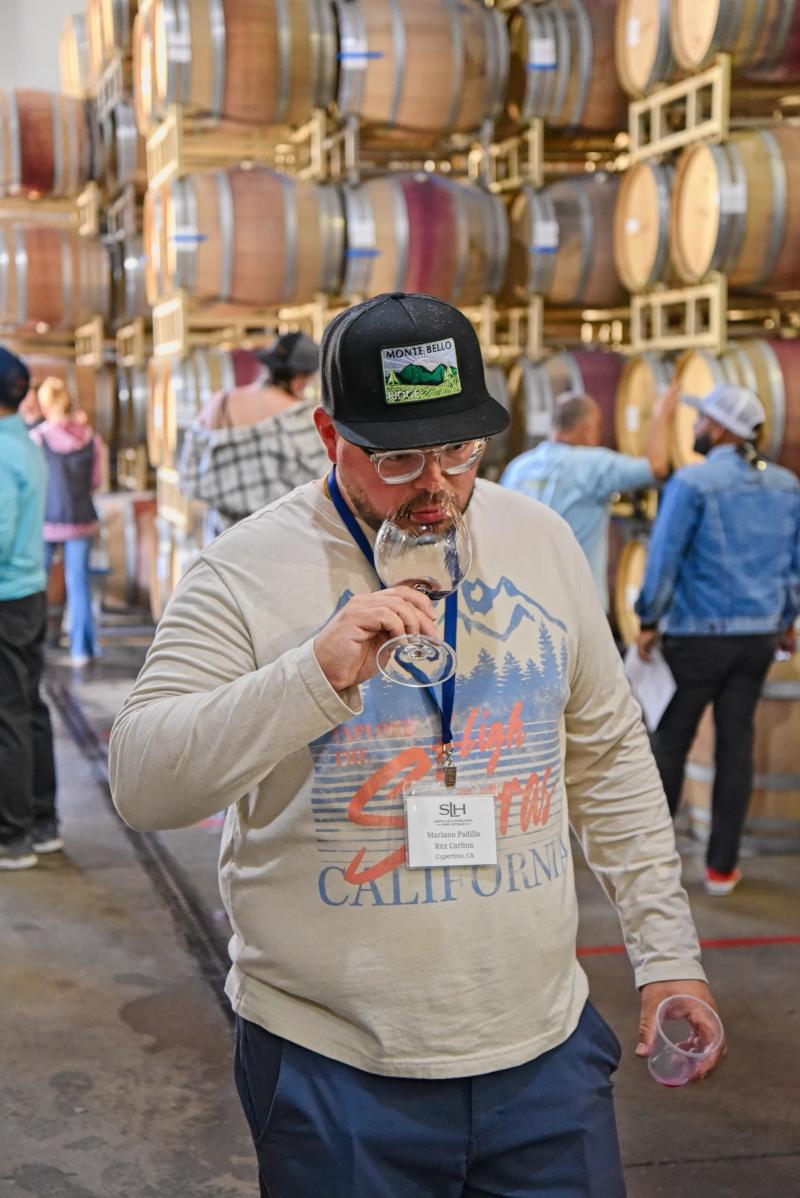Sommelier tasting wine at Wrath Wines during a Santa Lucia Highlands education event.