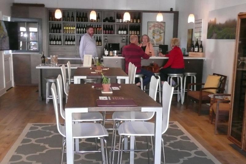 Windy Oaks tasting room in Carmel-by-the-Sea, with guests at the bar.
