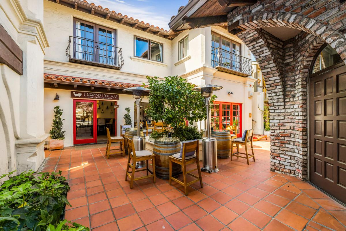 Dawn's Dream tasting room patio in Carmel, California, with wine barrels and seating.