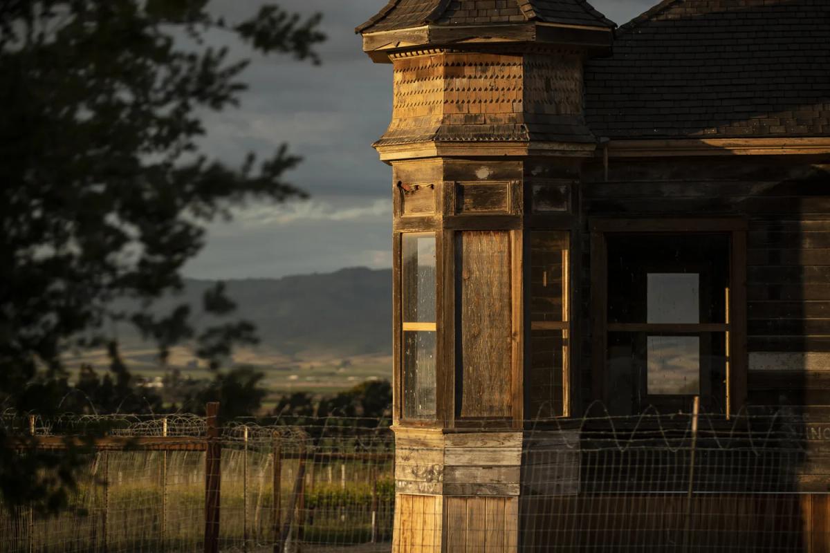 Historic wooden building in Santa Lucia Highlands, California, with vineyard views.