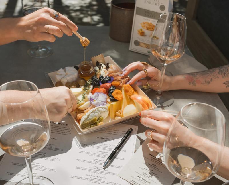 Wine tasting with cheese board and honey at Corral Wine Co tasting room in Carmel Valley, Monterey County.