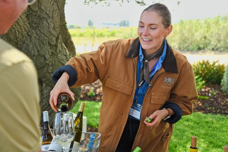 Sommelier pours wine at SLH Morgan Wines event at Double L Ranch, Monterey County.