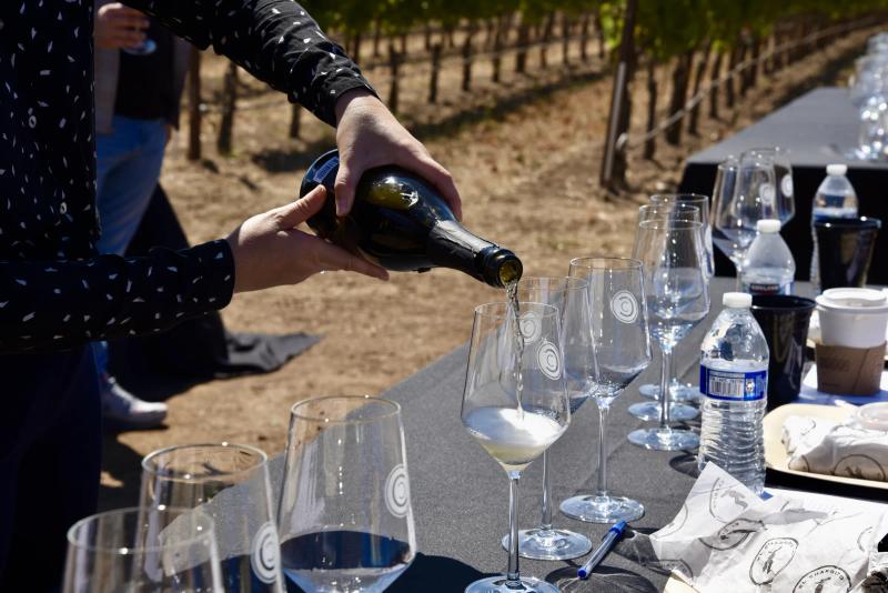 Wine pouring at a tasting event in Santa Lucia Highlands, Monterey County.