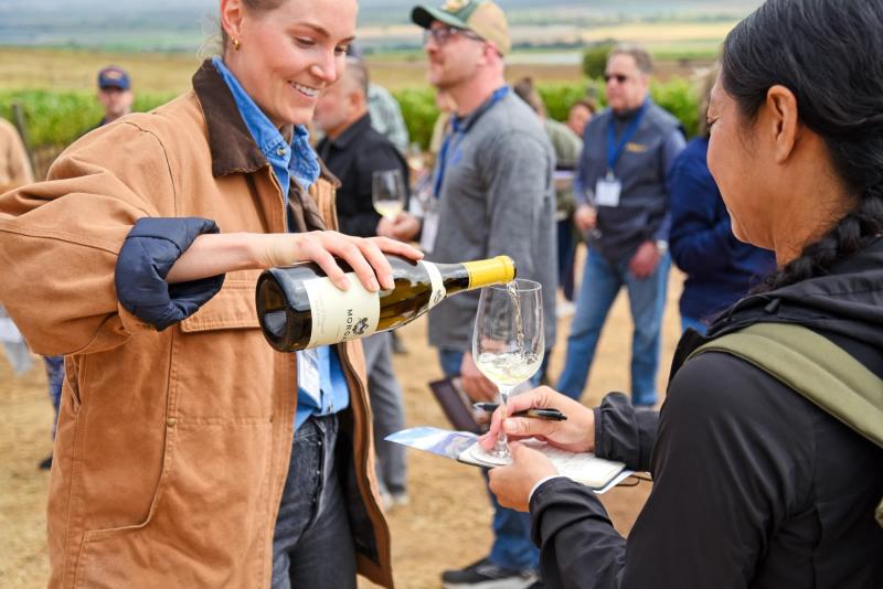 Sommelier pours wine at SLH education event at Morgan Double L Ranch.