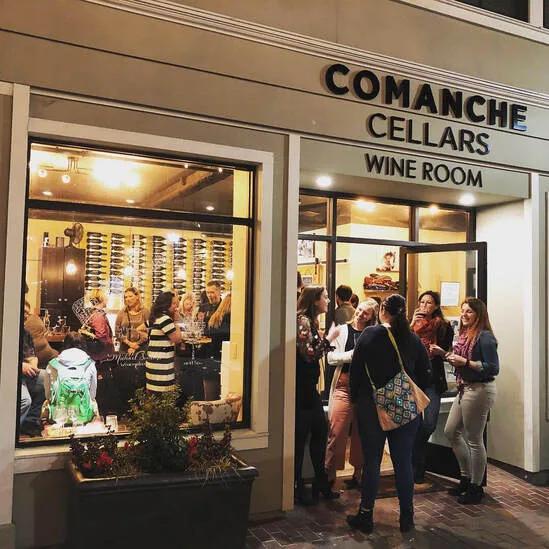 Comanche Cellars wine room in downtown Monterey County, California, with people gathered inside and outside.