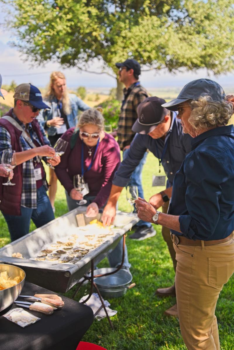 Sommeliers enjoy oysters at a Santa Lucia Highlands wine event at Morgan Wines.