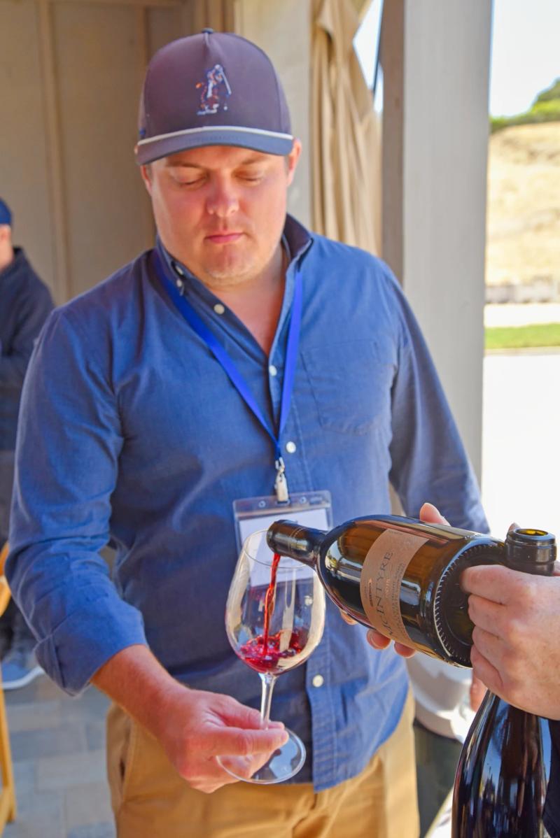 Sommelier pours wine at McIntyre Wines education event in Santa Lucia Highlands, Monterey County.