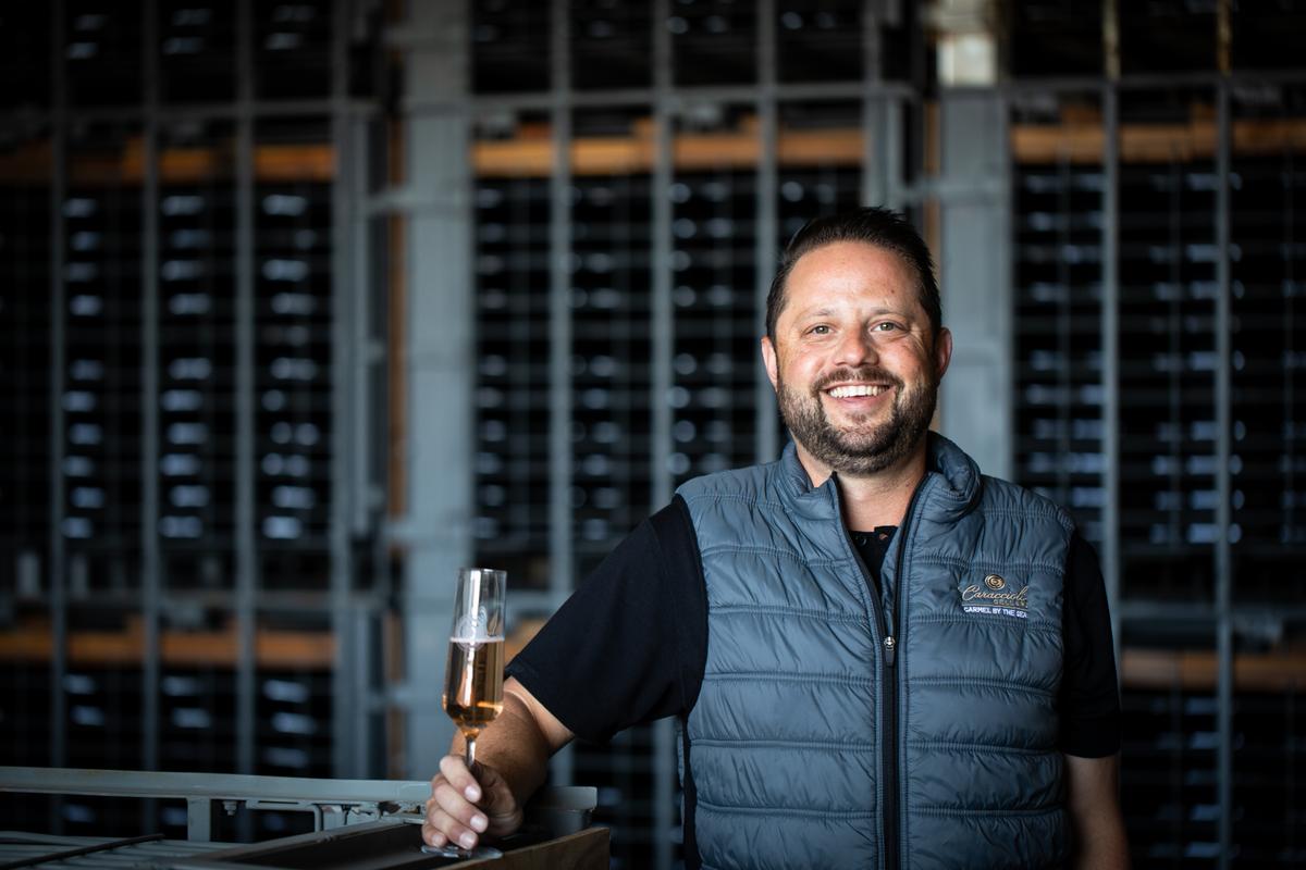 Scott Caraccioli, owner of Caraccioli Wines, holds a glass of wine in a cellar in SLH, Monterey County.