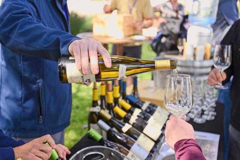 Sommelier pours wine at Morgan Wines education event, Santa Lucia Highlands, Monterey County.