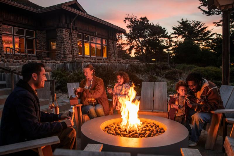 A family enjoying a firepit at Asilomar State Beach & Conference Grounds