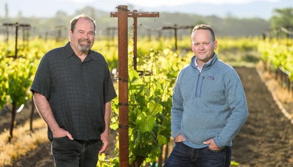 James Hall and a colleague stand in a vineyard in Santa Lucia Highlands, California.