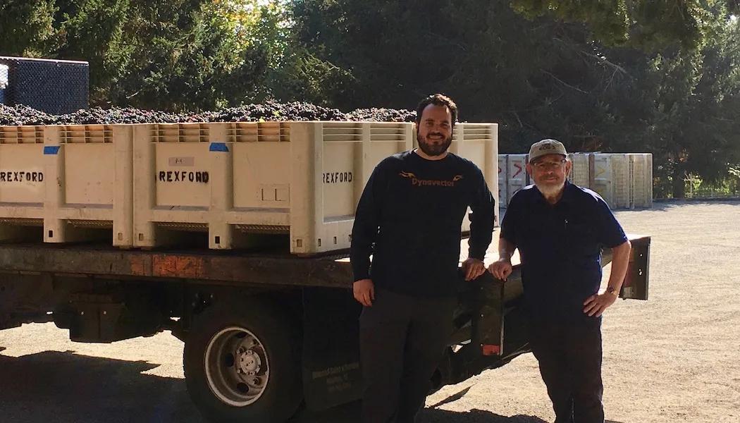 Two men stand by a truck loaded with Rexford Winery grape bins from Santa Lucia Highlands.