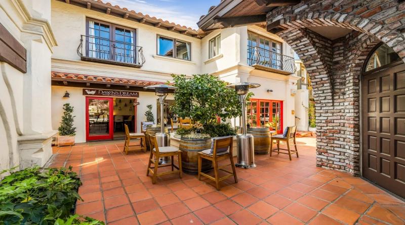 Dawn's Dream tasting room patio in Carmel, California, with wine barrels and seating.