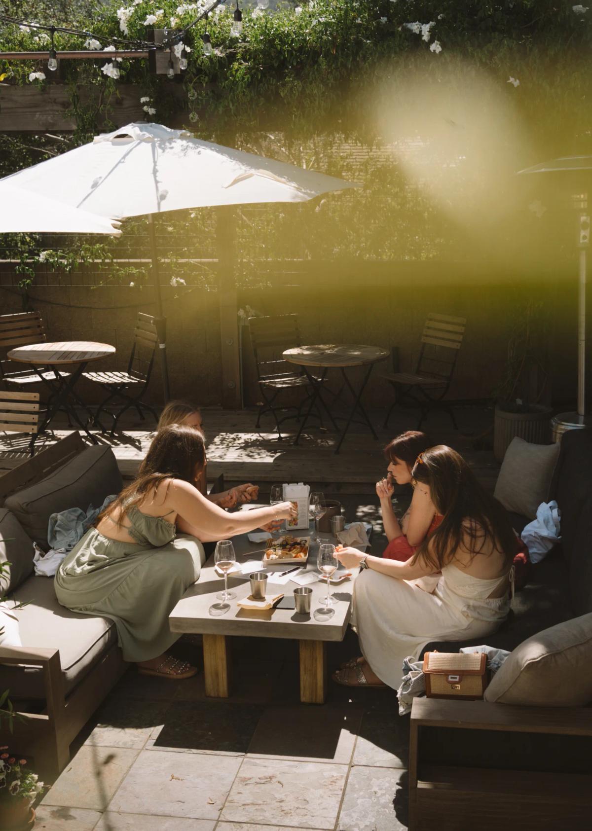 Friends enjoy wine tasting and appetizers at Corral Wine Co. in Carmel Valley, Monterey County.